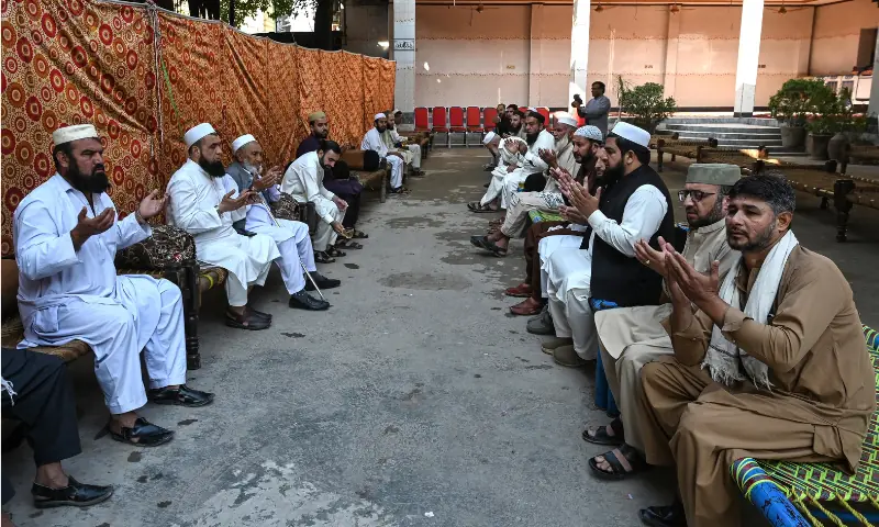 People pray for students killed after a roof collapsed at a school, in Peshawar on October 16, 2026. — AFP