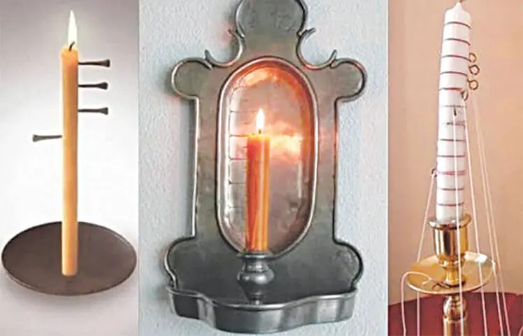 The gradual burning of a candle tracks time — lines on the wax or falling metal pins mark each hour as it passes