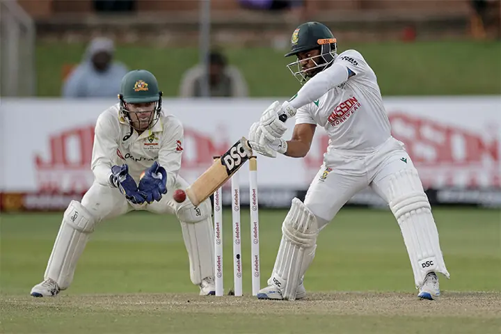   SOUTH AFRICAN captain Temba Bavuma plays a shot as Australia  wicket-keeper Alex Carey looks on during the second Test at St Georges Park on Tuesday.&mdash;AFP  