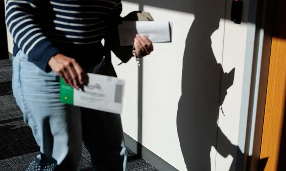 A Bucks County resident holds a mail-in ballot after voting &lsquo;On Demand&rsquo; using an absentee or mail-in ballot in Doylestown, Pennsylvania, the US on October 20, 2026. &mdash; Reuters