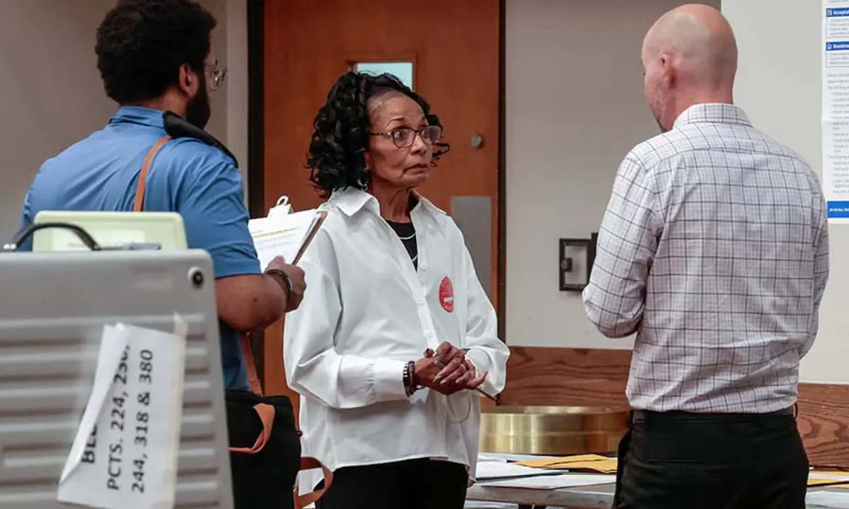 US Department of Justice (DOJ) poll watchers visit a polling station during the Michigan primary elections, in Detroit, Michigan, the US on August 4, 2026. &mdash; Reuters/File