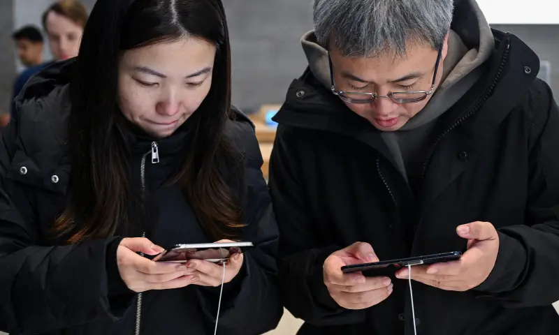 People use the new foldable iPhone Duo, on its launch day at an Apple store, in Berlin, Germany, on October 23, 2026. — Reuters