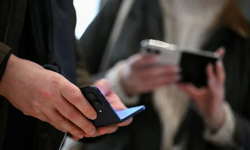 People use the new foldable iPhone Duo, on its launch day at an Apple store, in Berlin, Germany, on October 23, 2026. — Reuters