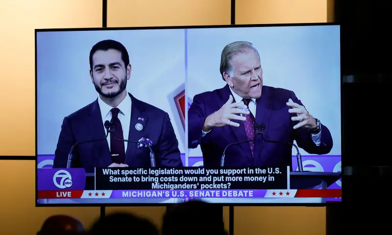 Democratic nominee for US Senate Abdul El-Sayed and Republican nominee for US Senate Mike Rogers are seen on a screen in the media room during their US Senate debate in Southfield, Michigan US, on October 21, 2026. — Reuters