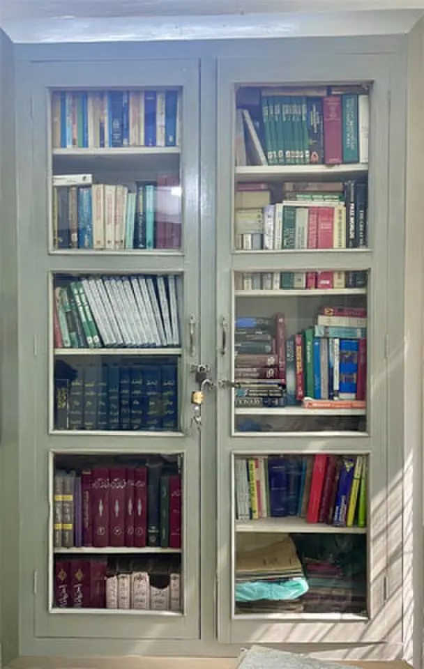   Books gather dust inside a locked cupboard in Iqbal Library.  