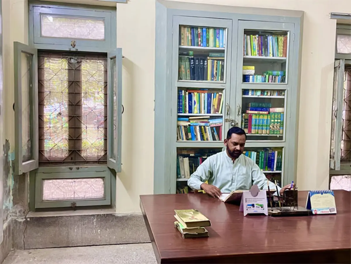   Syed Zishan Haider, who holds the additional charge of librarian, sits alone in his office in Iqbal Library.  