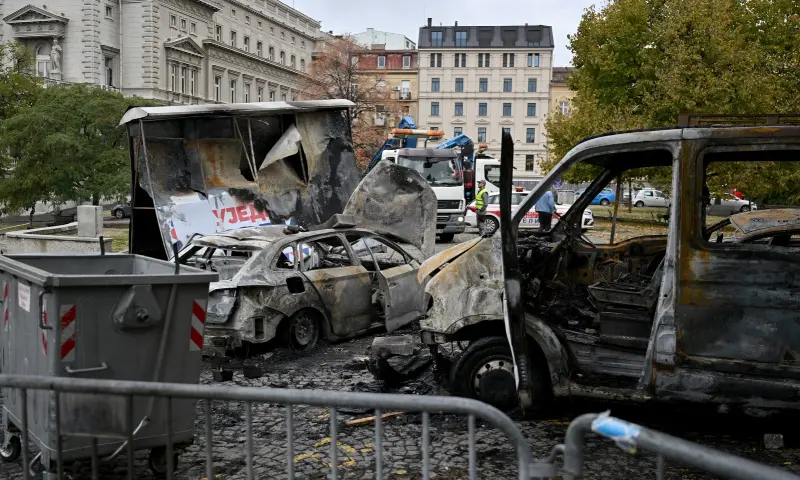 The charred remains of a pro-government encampment are pictured in a park opposite the Serbian Parliament in Belgrade on October 26, 2026, after crowds celebrating election results entered the site the previous night and dismantled tents that had occupied the area for months, setting them alight along with a number of cars. — AFP