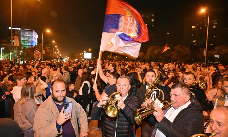 Supporters of the Students’ List wave a giant Serbian flag as they celebrate their victory in the Serbian parliamentary elections, in downtown Belgrade on October 25, 2026. — AFP