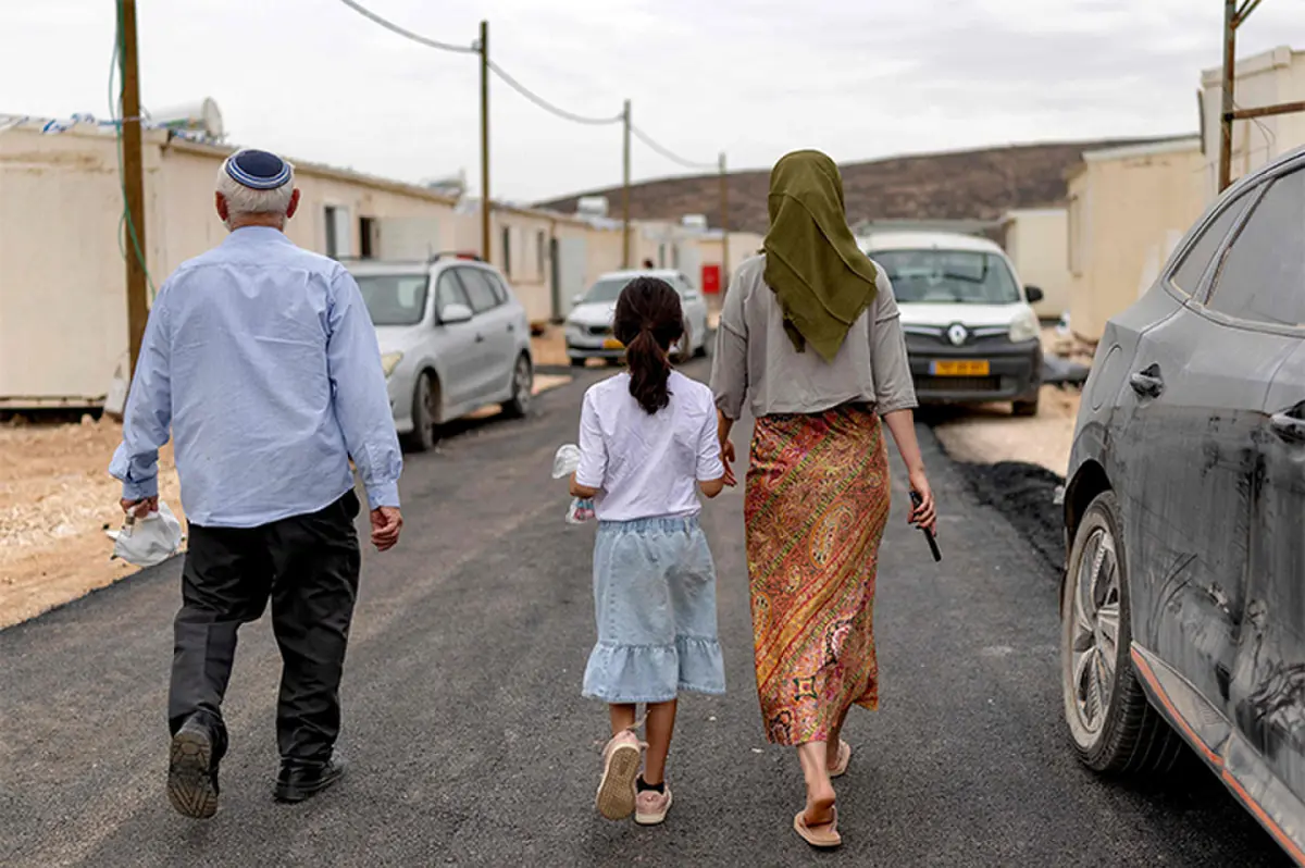 Israeli settlers walk during the opening of a new settlement near the Palestian village of Salem, in the occupied West Bank.—AFP