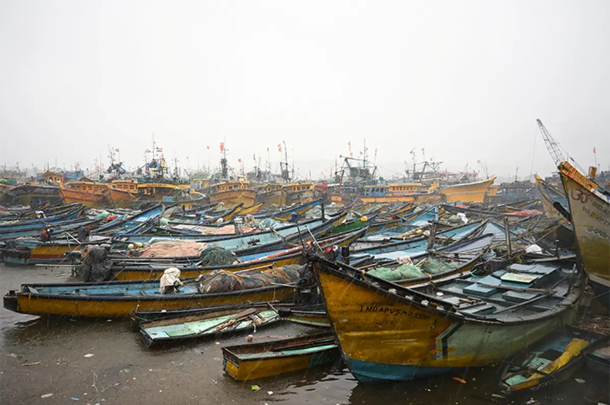 BOATS are docked along a harbour at Visakhapatnam, Andhra Pradesh, amid rain and gusty winds.—Reuters
