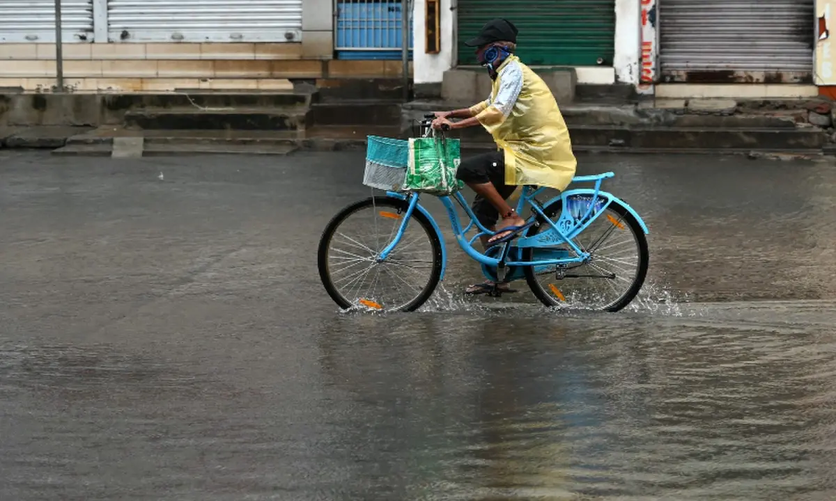 A man cycles through a water-logged street in Andhra Pradesh&rsquo;s Kakinada on October 28, 2026, ahead of cyclone Arnab&rsquo;s expected landfall.&mdash;AFP