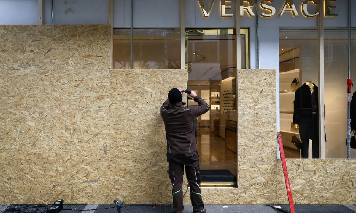 A worker secures a fashion store with wooden boards ahead of expected protests by the youth movement “Gen Z regelt” in Frankfurt, Germany, October 30, 2026. —Reuters