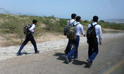 Older boys walk back home after attending their academic institution. —Photo by author