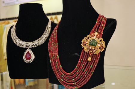 (Clockwise from top) Necklaces from Sherezade Rahimtoola’s jewelry collection; a hand embroidered piece by Shamsha Hashwani; and, a guest tries on an earring from Sherezade’s collection. Photos by the writer