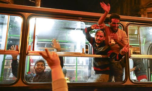 Migrants stream into Austria, swept west by overwhelmed Hungary