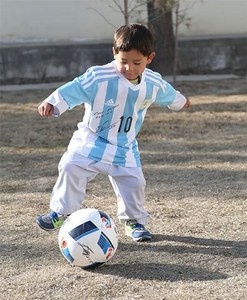 مرتضیٰ میسی کی شرٹ پہن کر فٹبال سے کھیلنے ہوئے۔ فوٹو بشکریہ یونیسیف