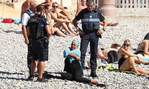 Woman forced to remove clothing on France beach after burkini ban Woman forced to remove clothing on France beach after burkini ban