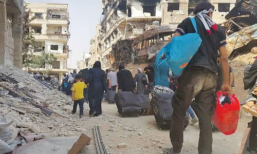 Rebels, civilians evacuate long-besieged Damascus suburb