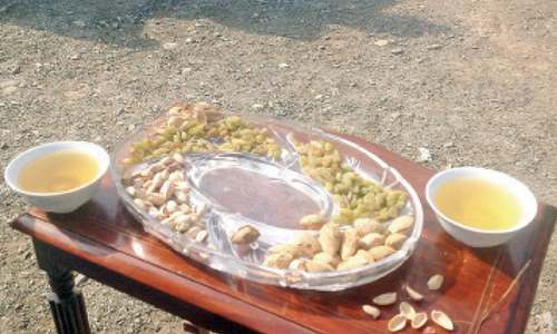 Serving guests with dry fruit, green tea a  special tribal Eid treat