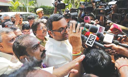 Indian police raid homes of ex-finance minister, son