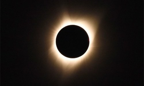 In pictures: moon blots sun out of the sky in historic eclipse