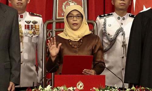 Singapore swears in first female president amid criticism