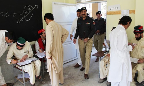 Police officials visit polling station as polling agents cater to voters. —Photo by Sirajuddin