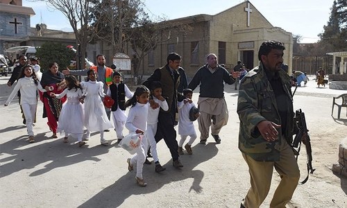 Children being evacuated from the church by security personnel. —AFP