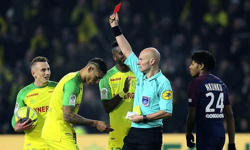 Referee banned for kicking footballer during a match