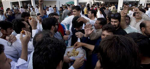 Sweets all around as PTI supporters celebrate Khan's ascent to prime minister