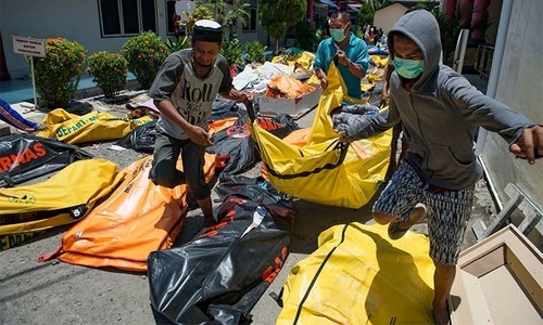 Aid rolls into Indonesia disaster city as more victims found