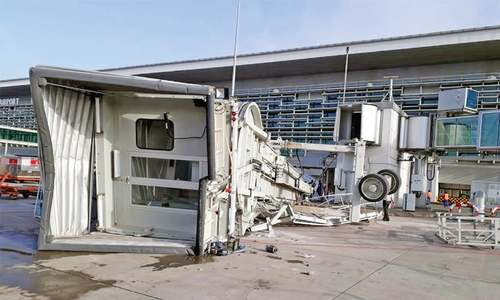 Two injured as passenger boarding bridge collapses at new airport Two injured as passenger boarding bridge collapses at new airport