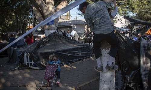 US police fire tear gas at migrants trying to cross from Mexico
