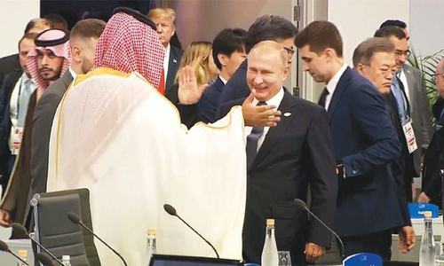 Saudi prince back on stage to Putin delight, Macron warning