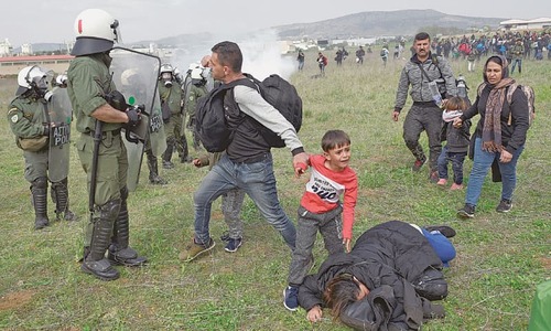 Greek police fire tear gas at migrants as border convoy grows