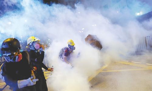 Hong Kong protesters seize roads in defiance of China warnings