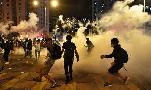 Second night of tear gas as Hong Kong protesters defy China warnings