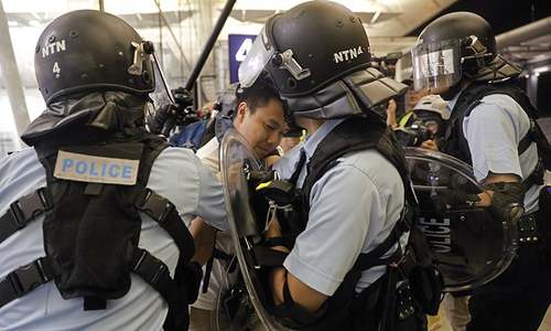 Trump confirms China moving troops to Hong Kong border as airport chaos enters second day