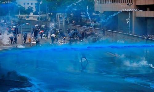 Police fire tear gas as protesters set fires in Hong Kong
