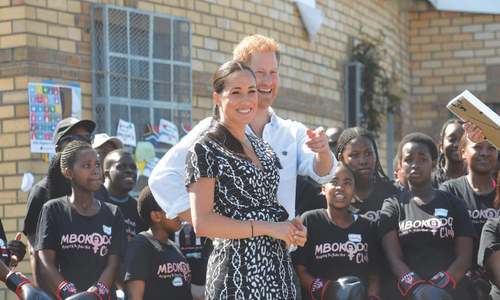 Harry and Meghan dance with youth mentors