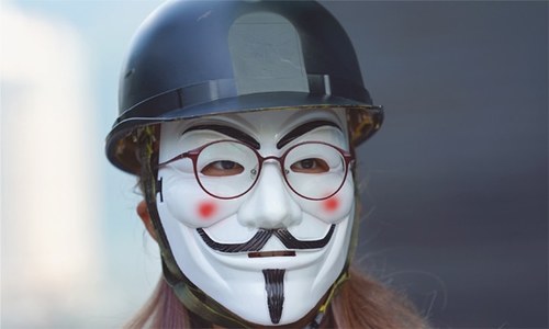 Shot Hong Kong protester charged as govt moves to ban face masks