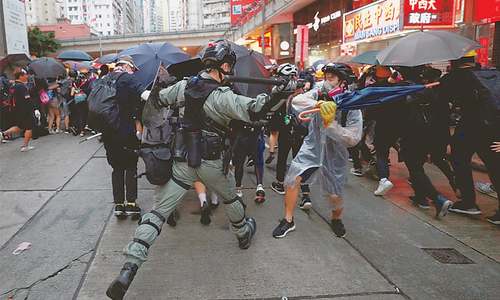 Chaos hits Hong Kong again as thousands defy mask ban