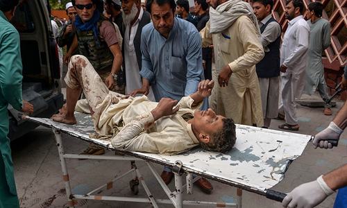 Afghans search for bodies after at least 69 killed in mosque explosions