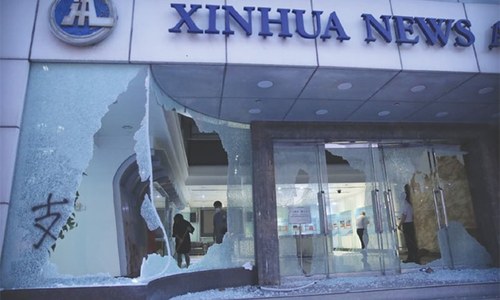 Hong Kong chaos sees tear gas, attack on Chinese news agency