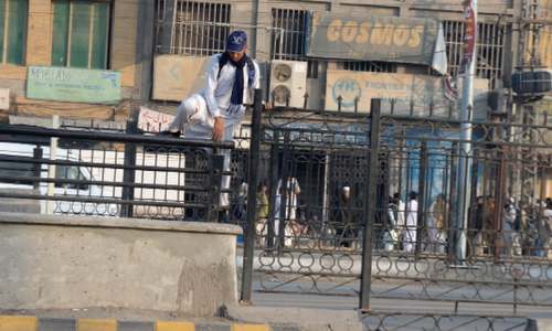 Shortage of crossings at Peshawar BRT pushes pedestrians to scale grills
