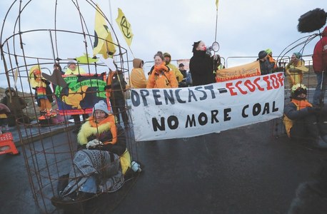 Environmentalists dressed as canaries protest plans to expand uk coal mine