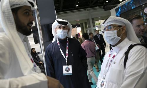 Visitors and exhibitors wear masks at the Arab Health Exhibition in Dubai on Jan 29. &mdash; AP