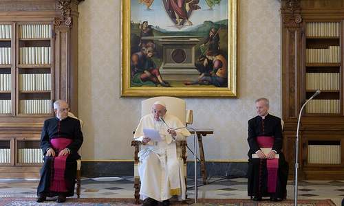This photo taken on March 11, shows Pope Francis, flanked by Monsignor Leonardo Sapienza (L) and Monsignor Luis Maria Rodrigo Ewart, holding a private and restricted weekly general audience in the library of the Apostolic Palace in the Vatican. — AFP