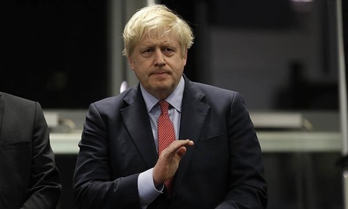 Johnson &lsquo;on top of things&rsquo;, but under fire over initial virus response