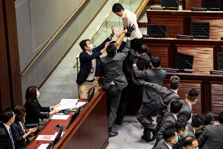 Hong Kong activists charged as clashes erupt in legislature
